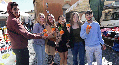 Students hold fresh oranges during an Education Abroad experience in Costa Rica